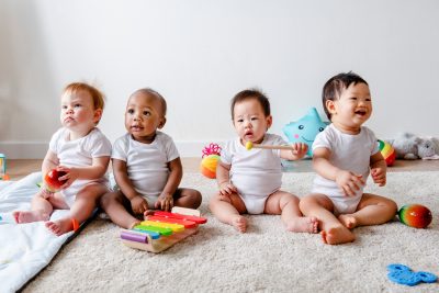 Babies playing together in a play room