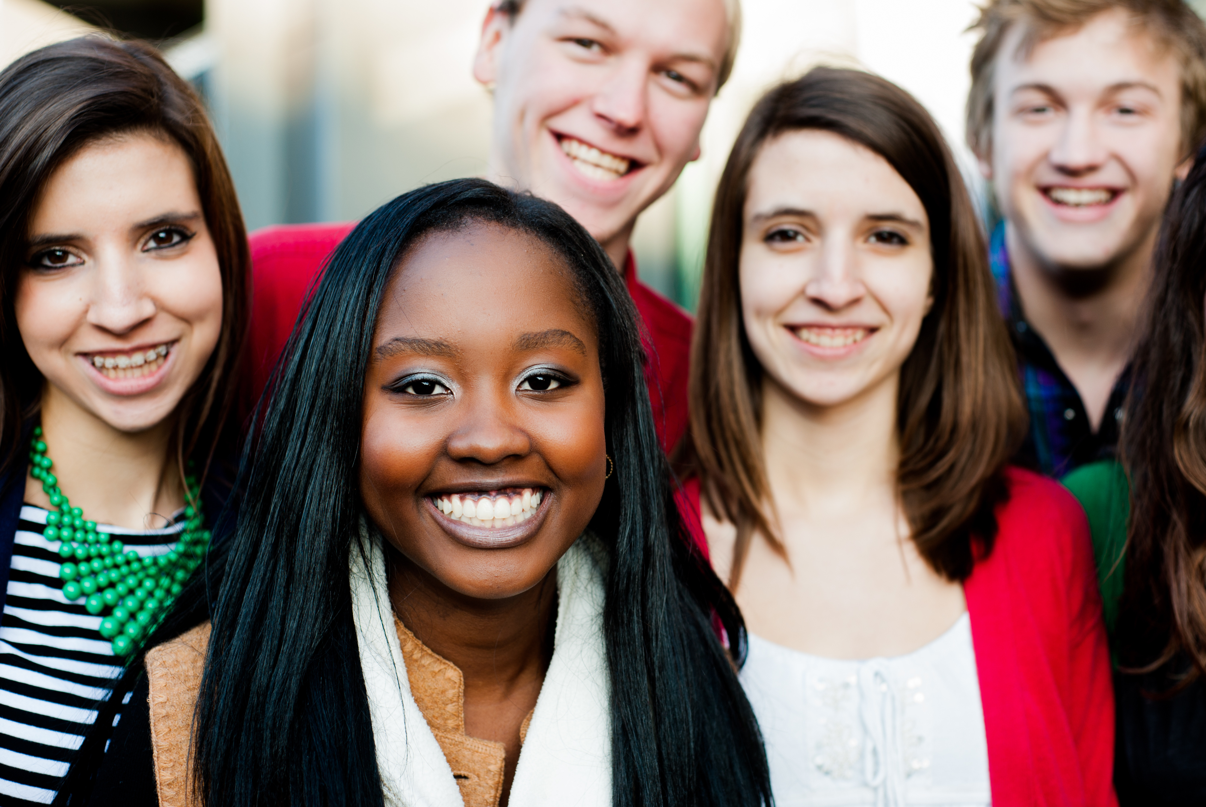 Group of diverse students outside smiling together